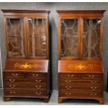 A superb pair of inlaid mahogany bureau book cases, W. 104cm. H. 214cm.