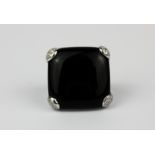 An 18ct white gold ring set with onyx and diamonds, L. 2.5cm, (K).