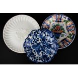 A Dutch Makkum polychrome plate together with a blue and white Makkum dish and a Delft commerative