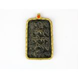 A Tibetan gilt mounted bronze amulet with coral bead decoration, H. 7.5cm.