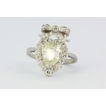 A white metal (tested 18ct gold) ring set with a modified pear cut diamond surrounded by brilliant