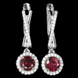A pair of 925 silver drop earrings set with round cut garnets and white stones, L. 2.3cm.