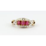 A 9ct yellow gold ring set with oval cut rubies and diamonds, (L).