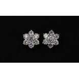 A pair of 18 ct white gold (stamped 750) diamond set daisy cluster earrings set with brilliant cut