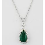 An 18ct white gold (stamped 750) necklace set with a pear cut emerald and brilliant cut diamonds,