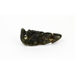 An important archaic form dark green/black jade amulet resembling a stylised head, H. 6.5cms.
