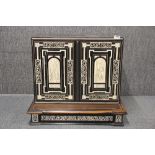 An 18th C. continental mahogany inlaid ebony cabinet with later interior, W. 70cm. H.62cm.