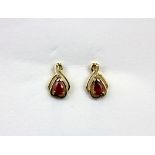 A pair of 9ct yellow gold earrings set with pear cut rubies and diamonds, L. 1.2cm.