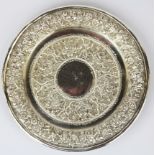 A Persian hammered white metal (tested silver) dish, approx. 153gr, Dia. 16cm.