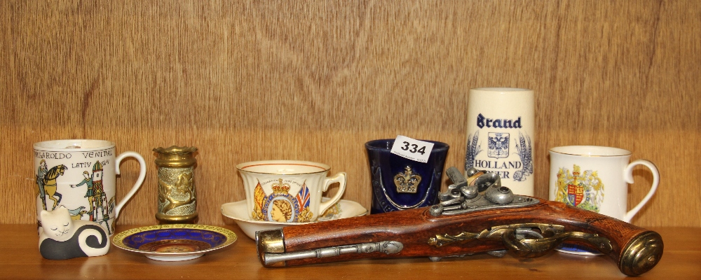 A small trench art brass vase with a Limoges Bayeux tapestry mug, replica flint lock pistol and