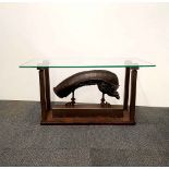 A hand-made iron sculpture glass topped 'Alien' inspired coffee table, 58cm x 107cm x 46cm.