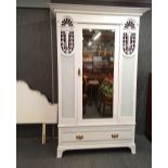 An Art Nouveau white painted single door wardrobe and similarly decorated headboard, 215 x 137 x