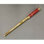 An antique brass and wood telescope, closed length 24cm. Not fully functional.