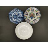 A Dutch Makkum polychrome plate together with a blue and white Makkum dish and a Delft commerative