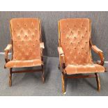 A pair of button backed mahogany arm chairs, 90cm x 65cm x 59cm.