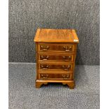 A small four drawer reproduction chest of drawers, 63 x 45 x 33cm.