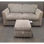 A contemporary grey fabric three seater sofa together with a storage compartment footstool.