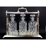 A Grinsell Patent silver plated tantalus with three cut glass bottles, 35 x 40cm.