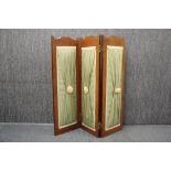 A double sided three panel folding screen, H. 81cm.