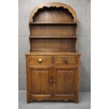 An oak linen fold dresser, W. 95 x 44cm. H. 179cm.