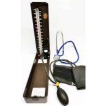 A vintage medical blood pressure gauge and stethoscope.