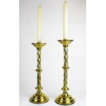 Two matching 19th century brass candlesticks, H. 44 & 46cm.