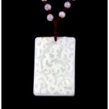 A Chinese carved nephrite jade amulet with crystal bead cord, amulet size 6.5 x 4.5 x 4.1cm.