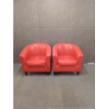 Two contemporary red faux leather upholstered armchairs, 73cm x 70cm x 81cm.