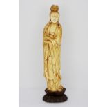 A large 19th/early 20th century Chinese carved ivory figure of the goddess Guanyin with remnants