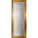 A gilt framed bevelled dressing mirror, W. 68cm. H. 170cm.