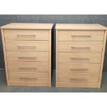 A pair of contemporary five drawer chests with a matching pair of bedside tables.