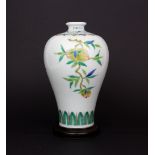 A Chinese hand painted porcelain vase. H.18cms, with turned wooden stand. Condition: no visible
