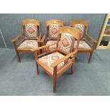 A set of four impressive brass inlaid Arts and Crafts period oak arm chairs.