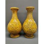 A pair of impressive Chinese yellow glazed and relief decorated porcelain vases depicting immortals,