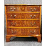 A serpentine front burr veneered four drawer chest, H. 84cm.