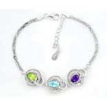 A 925 silver bracelet set with oval cut peridot, topaz and amethyst, L. 17cm.