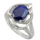 A 925 silver ring set with an oval cut sapphire and white stones, (P).