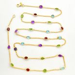 A 925 silver gilt necklace set with faceted cut blue topaz, iolite, amethyst, perditos and