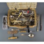 A wicker basket together with a quantity of silver plated cutlery, 43 x 28 x 17cm.