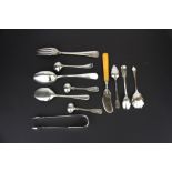 A group of eleven hallmarked silver cutlery items including sugar tongs, etc.