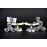A pair of J. Dixon & Son hallmarked silver and ivory knife rests, together with a pair of silver pla