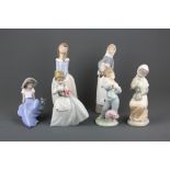 Five Nao porcelain figurines with a Lladro figurine of a girl with a lamp, tallest H. 28cm.
