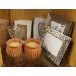 A pair of incense perfumed candles, a cut glass vase and a quantity of contemporary photo frames.