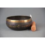 A Tibetan bronze singing bowl and hammer, Dia. 13cm.