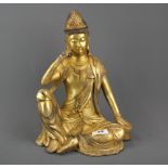 A Tibetan gilt bronze figure of a seated Deity, H. 33cm.