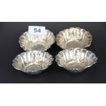 Four stamped silver shell dishes, dia. 8cm.