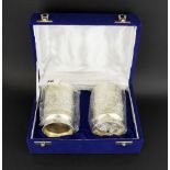 A boxed pair of Indian engraved silver cups, H. 10cm.