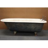 A vintage enamelled roll top bath with iron feet, 167cm.