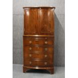 A mahogany veneered drinks cabinet, 130cm.