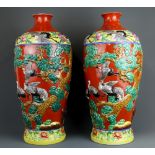 A pair of large 19th/20th century Chinese relief decorated and hand painted porcelain vases, H. 58cm